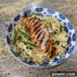 Delicious One-Pan Creamy Chicken and Asparagus Parmesan Orzo in a skillet