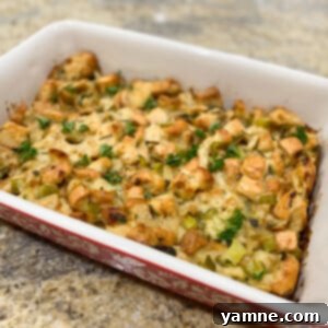 A beautifully baked traditional Thanksgiving stuffing with herbs, golden brown and garnished.