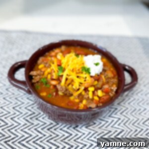 Hearty Slow Cooker Taco Soup, garnished with fresh cilantro and a dollop of sour cream