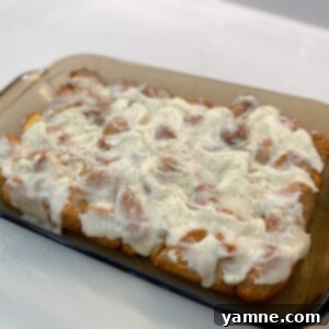 Mini Cinnamon Swirls 2 Gooey, Iced Cinnamon Roll Bites fresh from the oven, drizzled with sweet glaze