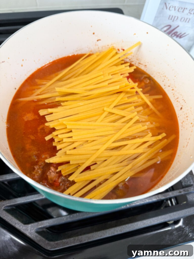 Adding tomatoes and pasta