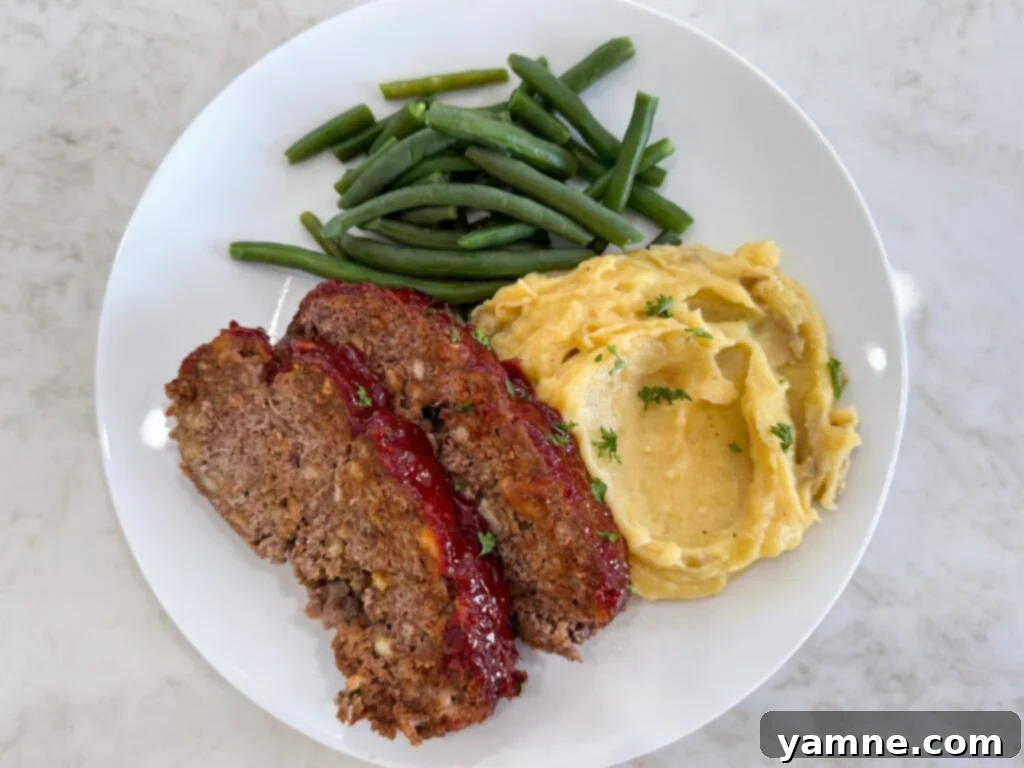 Classic homemade meatloaf with ketchup glaze, sliced and ready to serve