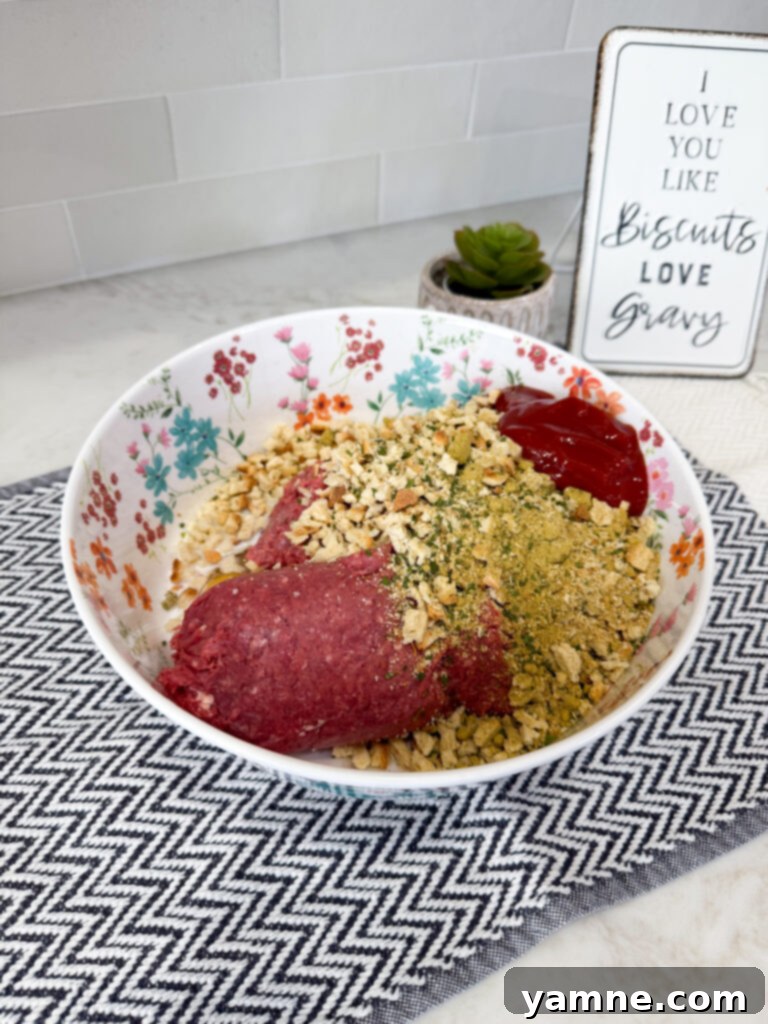Mixing ground beef, stuffing mix, eggs, milk, and ketchup in a large bowl