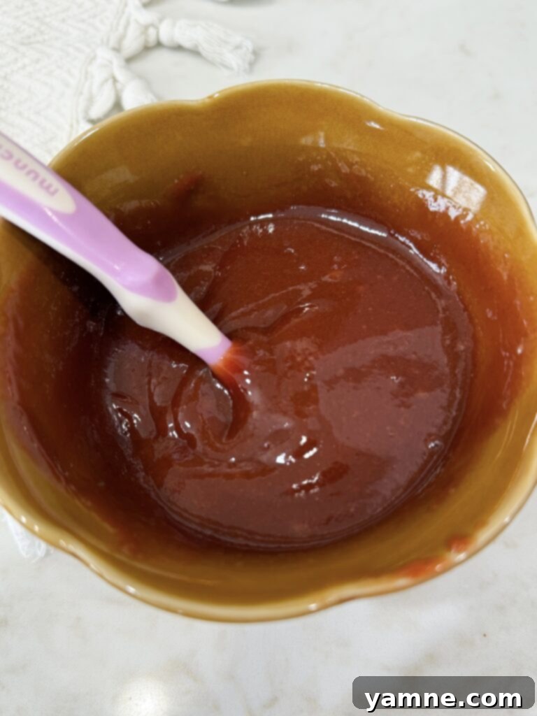 Preparing the sweet and savory ketchup glaze in a small bowl