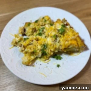 Hearty slow cooker tater tot, sausage, and egg breakfast casserole with melted cheese