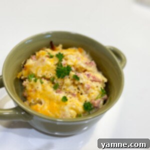 A top-down view of a golden-brown Crockpot Cracker Barrel Hash Brown Casserole, served in a slow cooker, with visible melted cheese and hash browns.