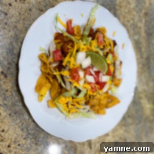 Delicious Frito Pie served with fresh toppings like lettuce, cheese, and tomatoes. A perfect 20-minute Tex-Mex dinner.