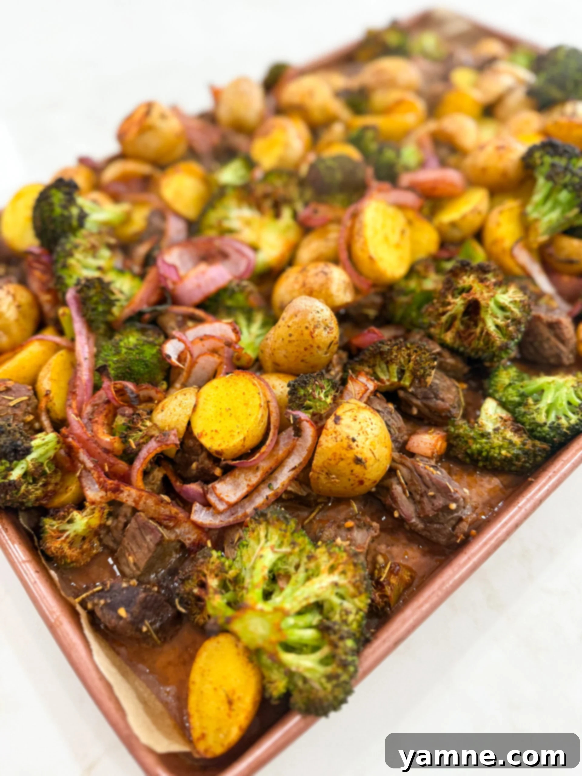 Garlic Butter Steak Bites with Roasted Veggies 5 Roasted steak bites and vegetables on a sheet pan